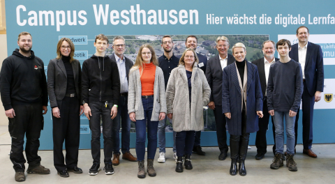 Die Referierenden freuen such über das gelungene Event Gruppenbild Vortagende vor Infotafel